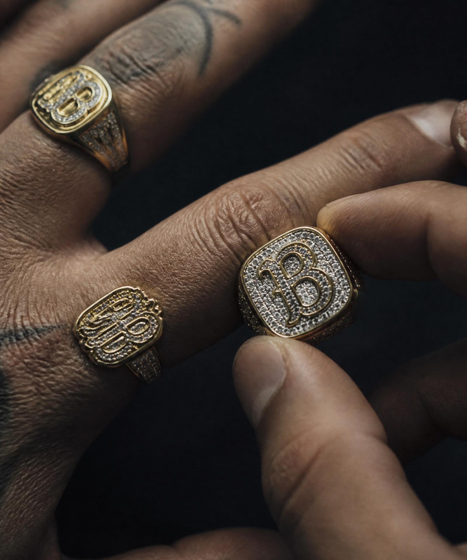 Custom iced-out signet rings on hand